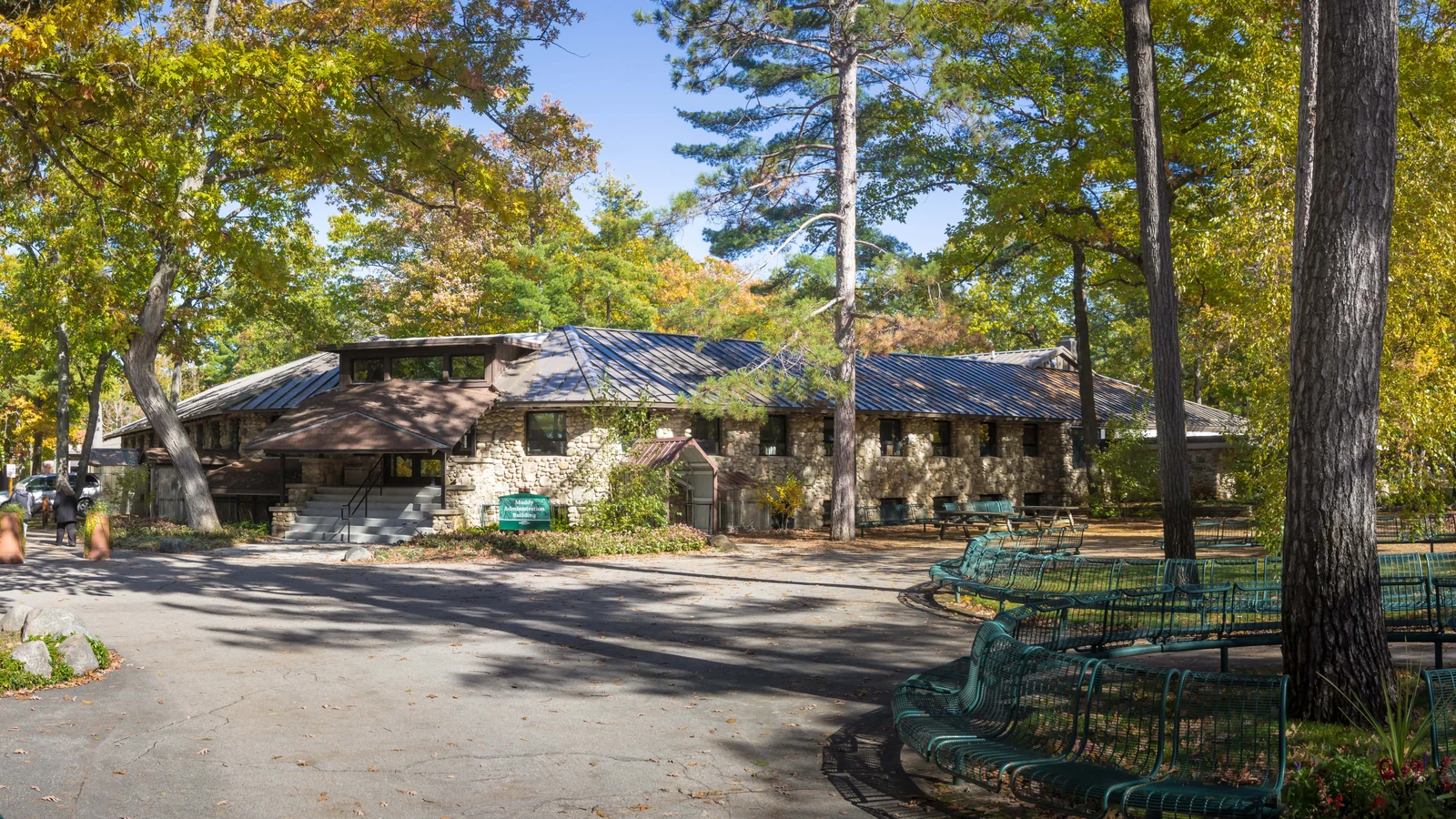 Stone administration building at Interlochen Center for the Arts surrounded by trees.
