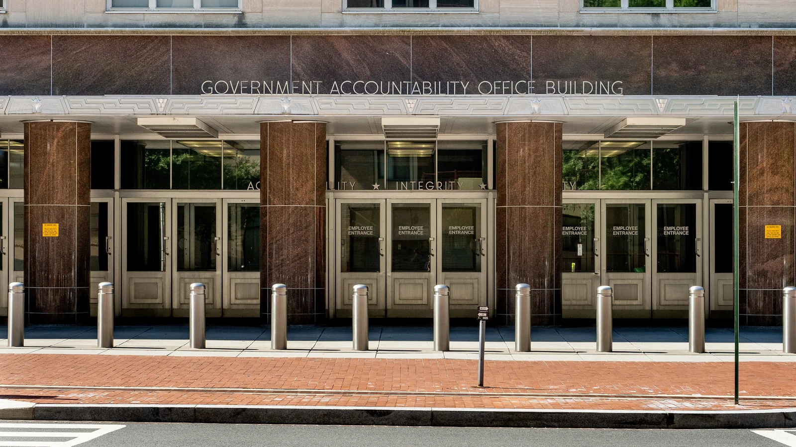 Street-level facade and employee entrances of the Government Accountability Office building in Washington.
