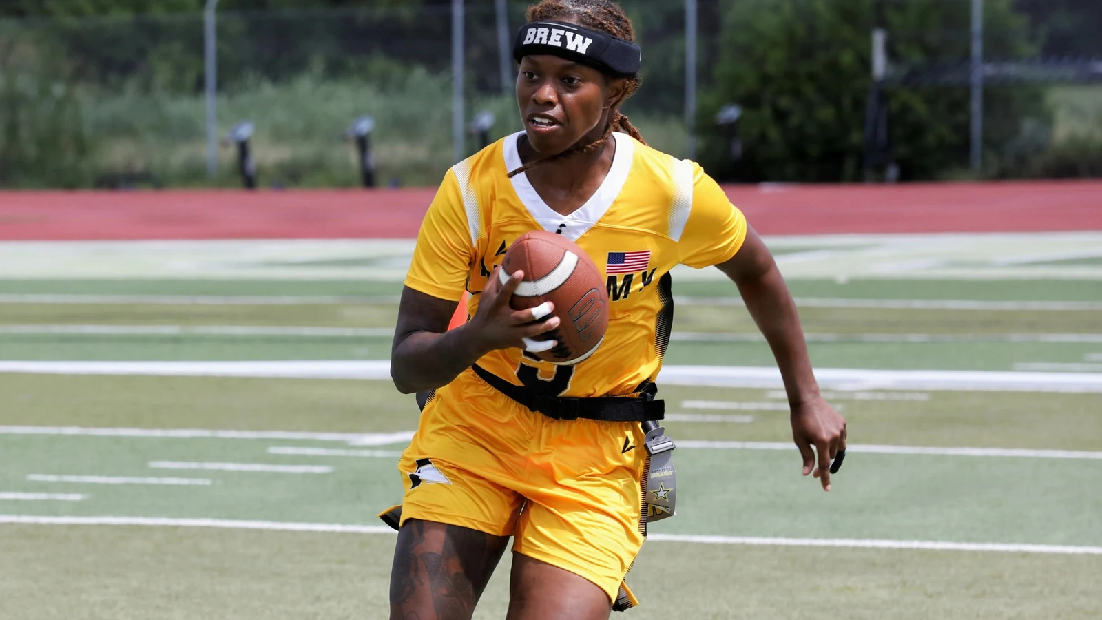 Army first lieutenant Brittany Gardner carries the football during the Armed Forces Women’s Flag Football Championship.