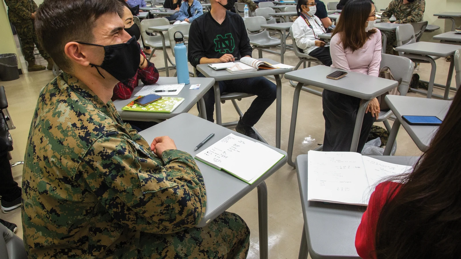 Adult students and volunteers take part in an English class in Okinawa, Japan.