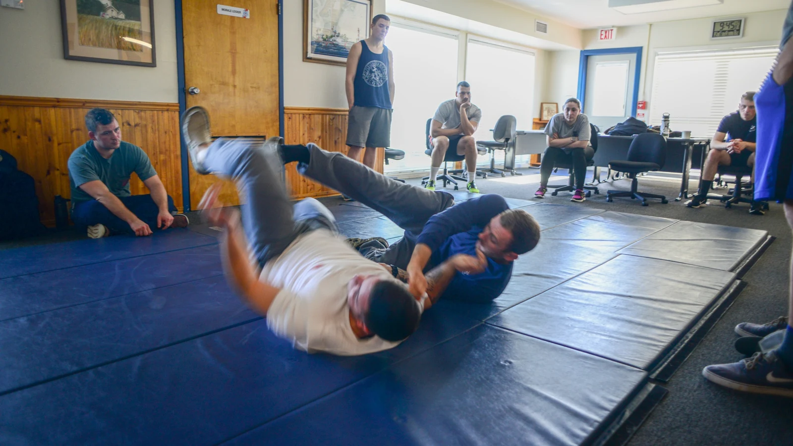 Two Coast Guard members demonstrate a ground-control technique during law-enforcement training.
