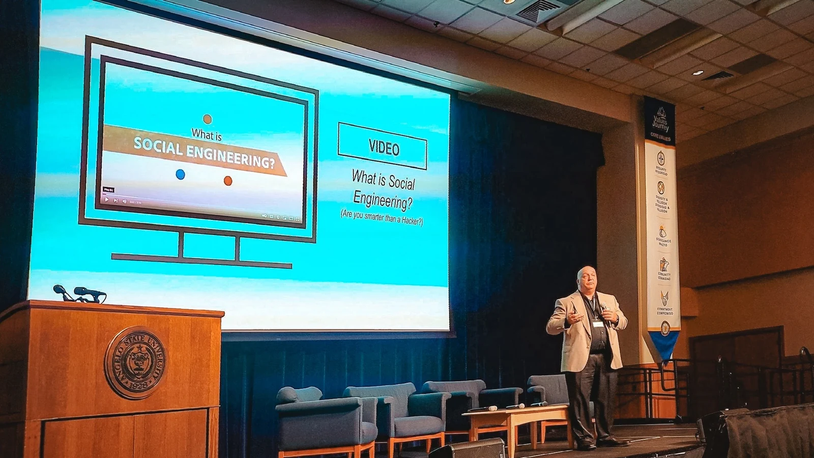 An instructor addresses older adults during a cybersecurity and fraud-awareness class.