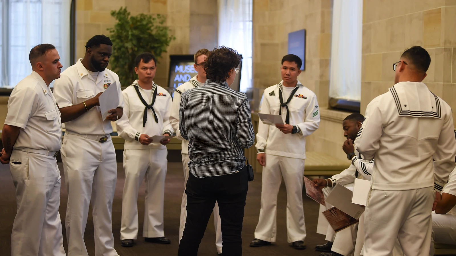 Sailors listen to a guide inside the Federal Reserve Bank of New York.