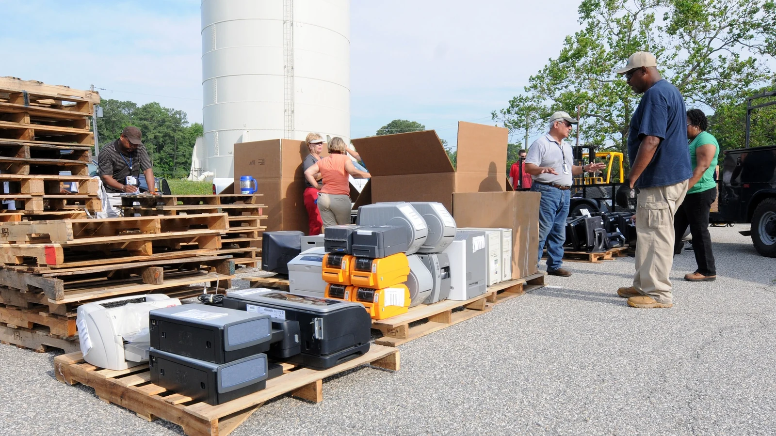 Workers process computers and other electronic waste at a Navy electronics-recycling event.