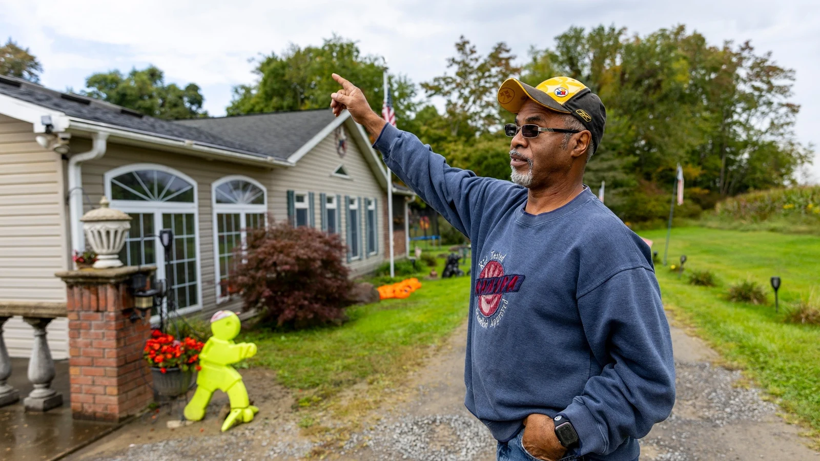A resident speaks with local firefighters near a fenced radioactive-waste cleanup site.