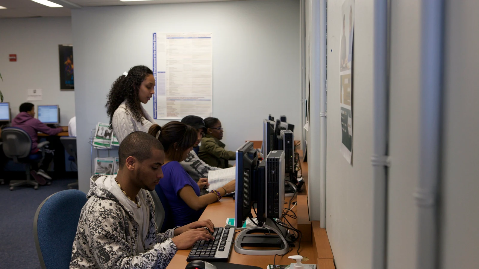 Adult community-college participants work at desktop computers during a U.S. Department of Education forum.