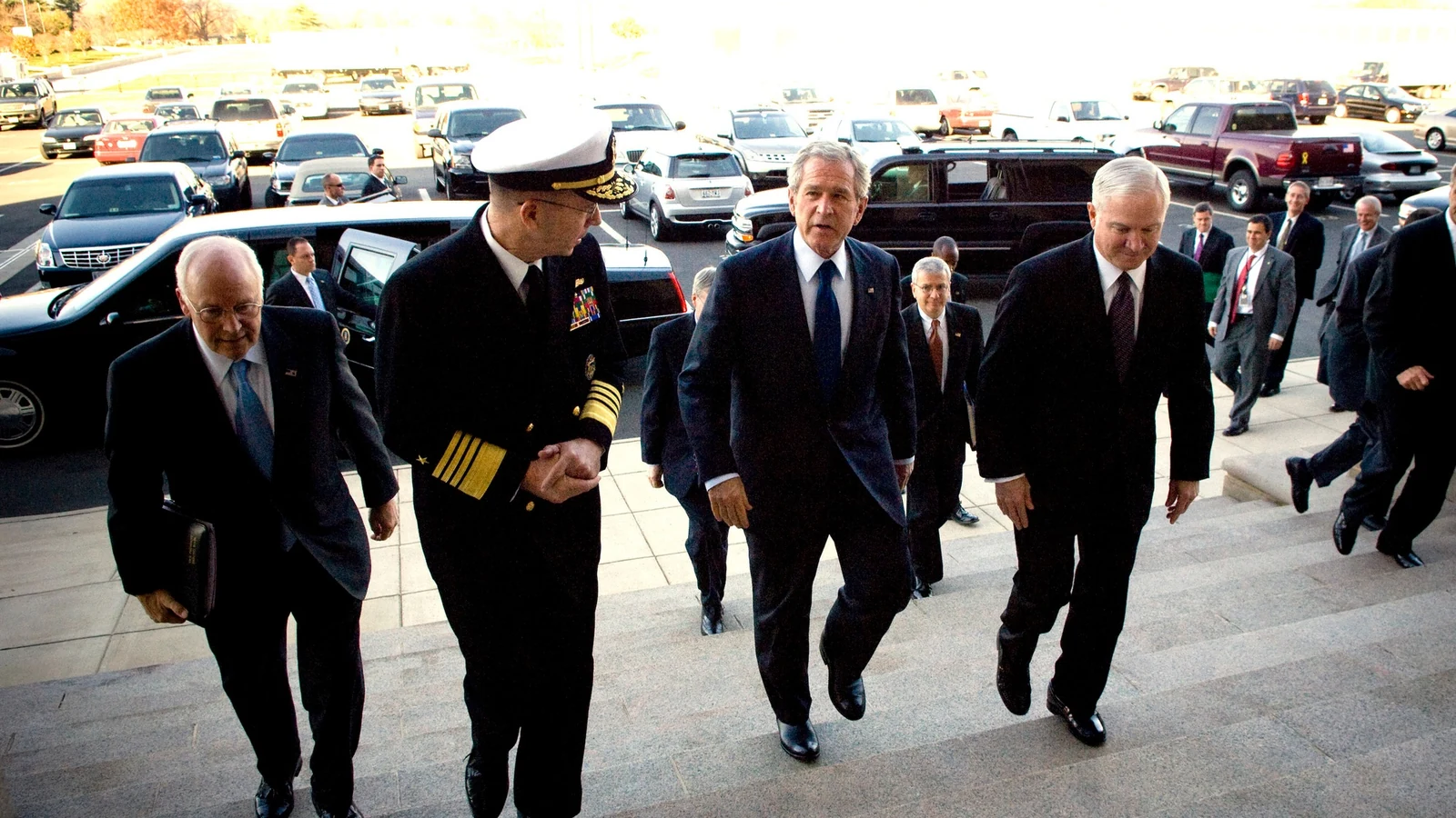 Senior federal leaders walk together through a Pentagon corridor on their way to a strategy meeting.