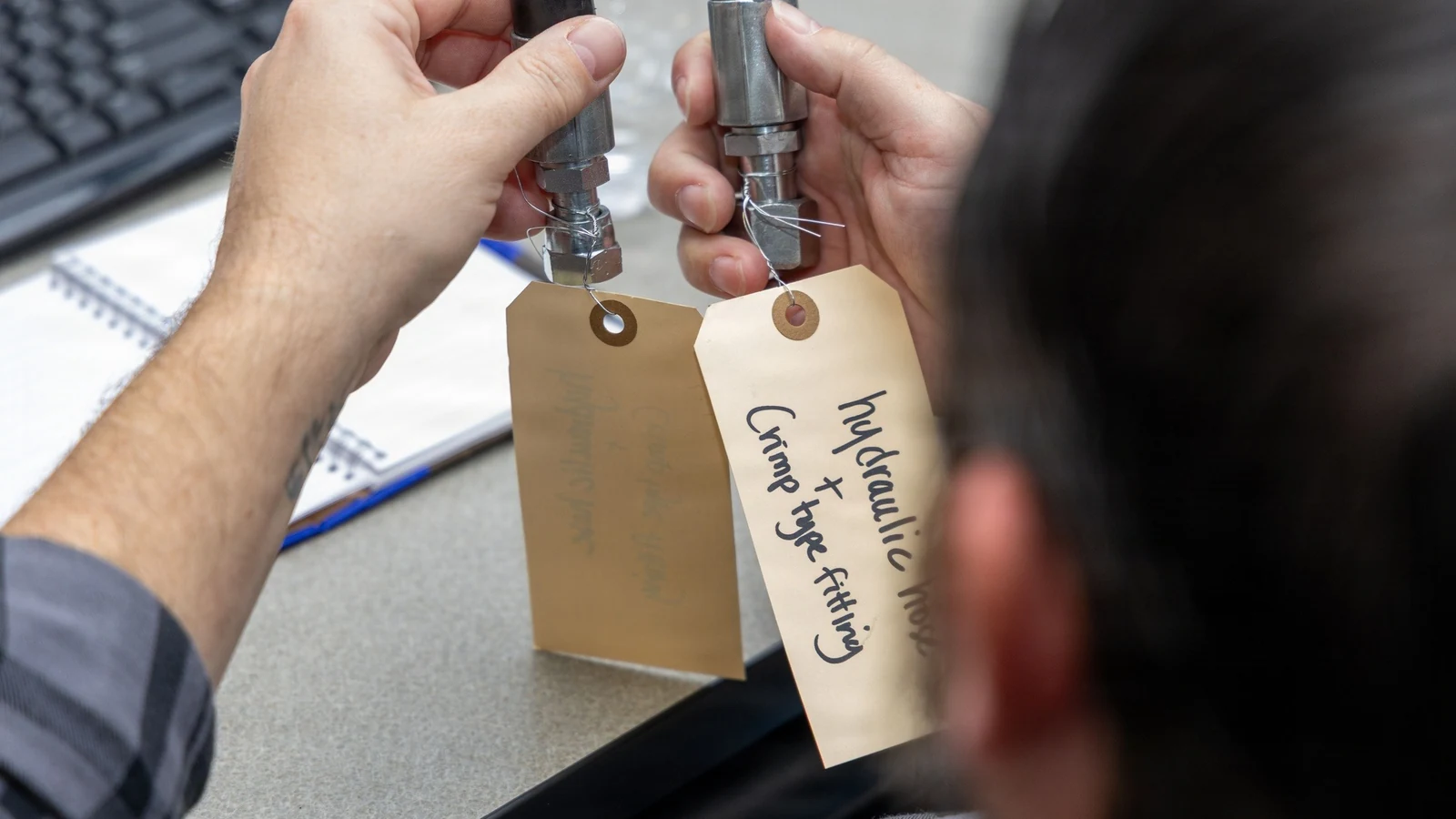 Federal acquisition employees examine components during a hands-on training session.