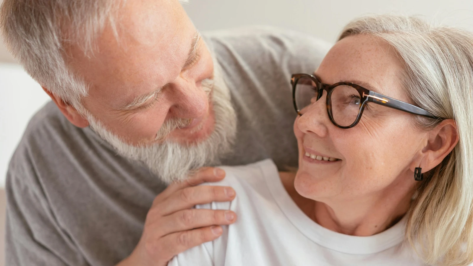 An older couple reviews health coverage information together at home.