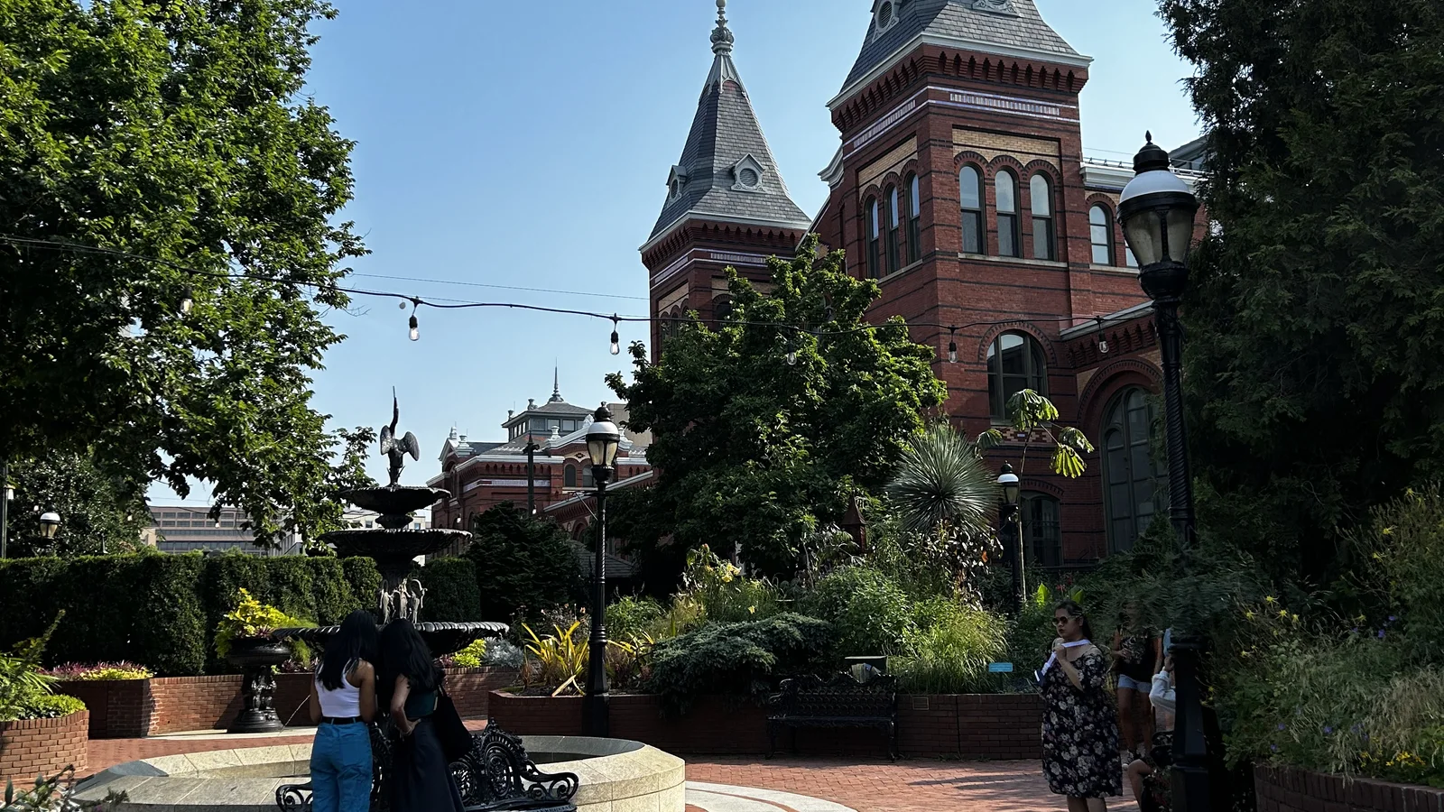 Red-brick Smithsonian Arts and Industries Building seen beyond a formal garden.