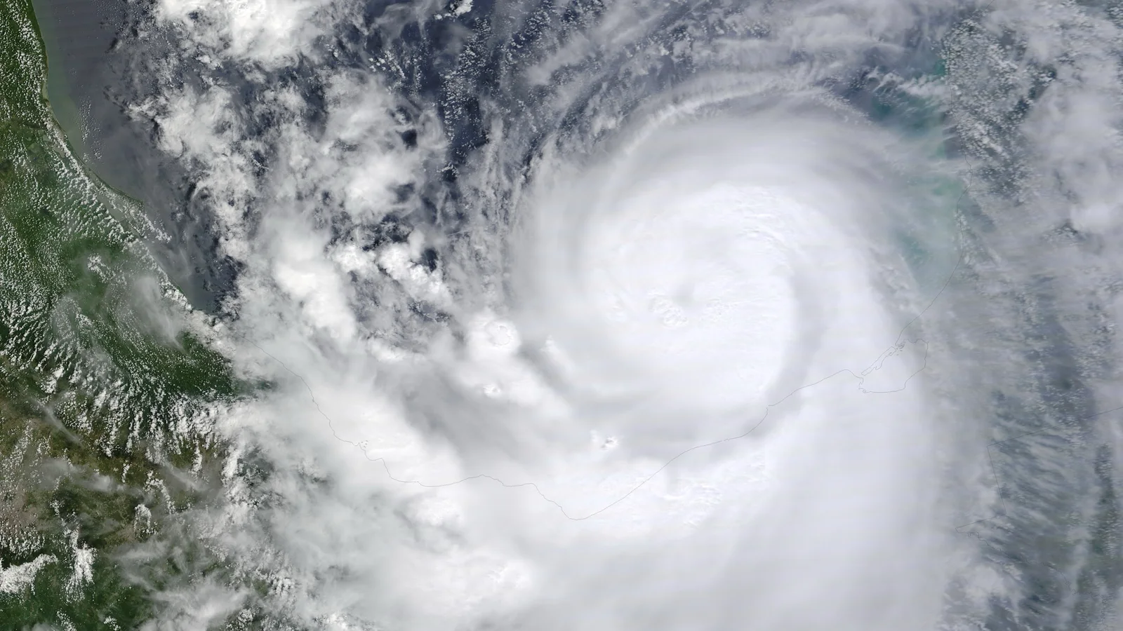 Large hurricane swirls over blue ocean in a NASA satellite view.