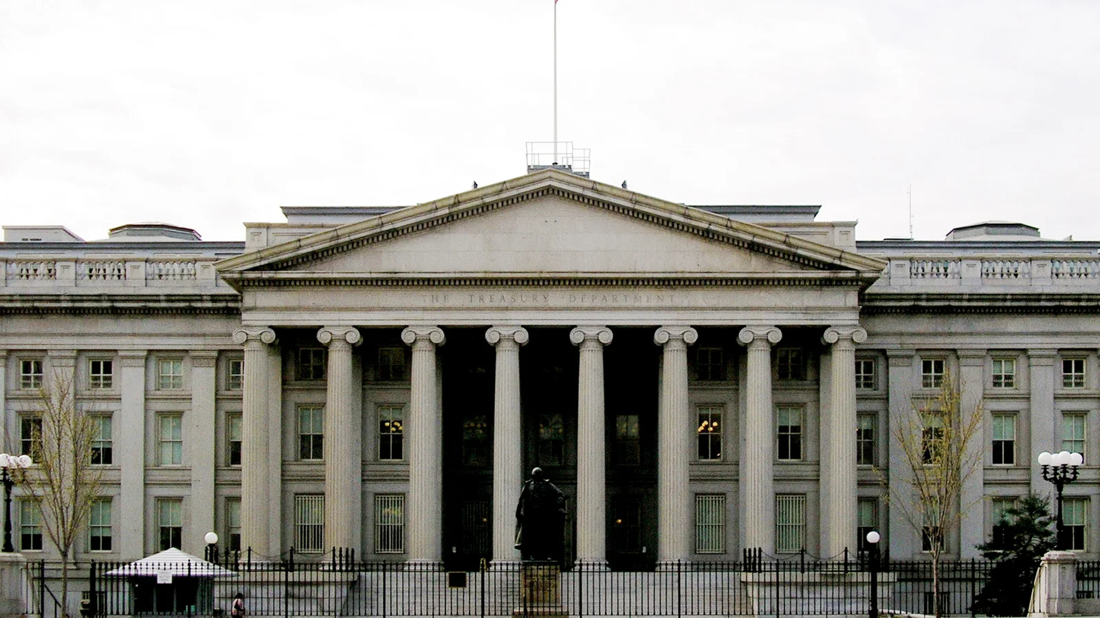 The columned U.S. Treasury Building seen from a Washington street.
