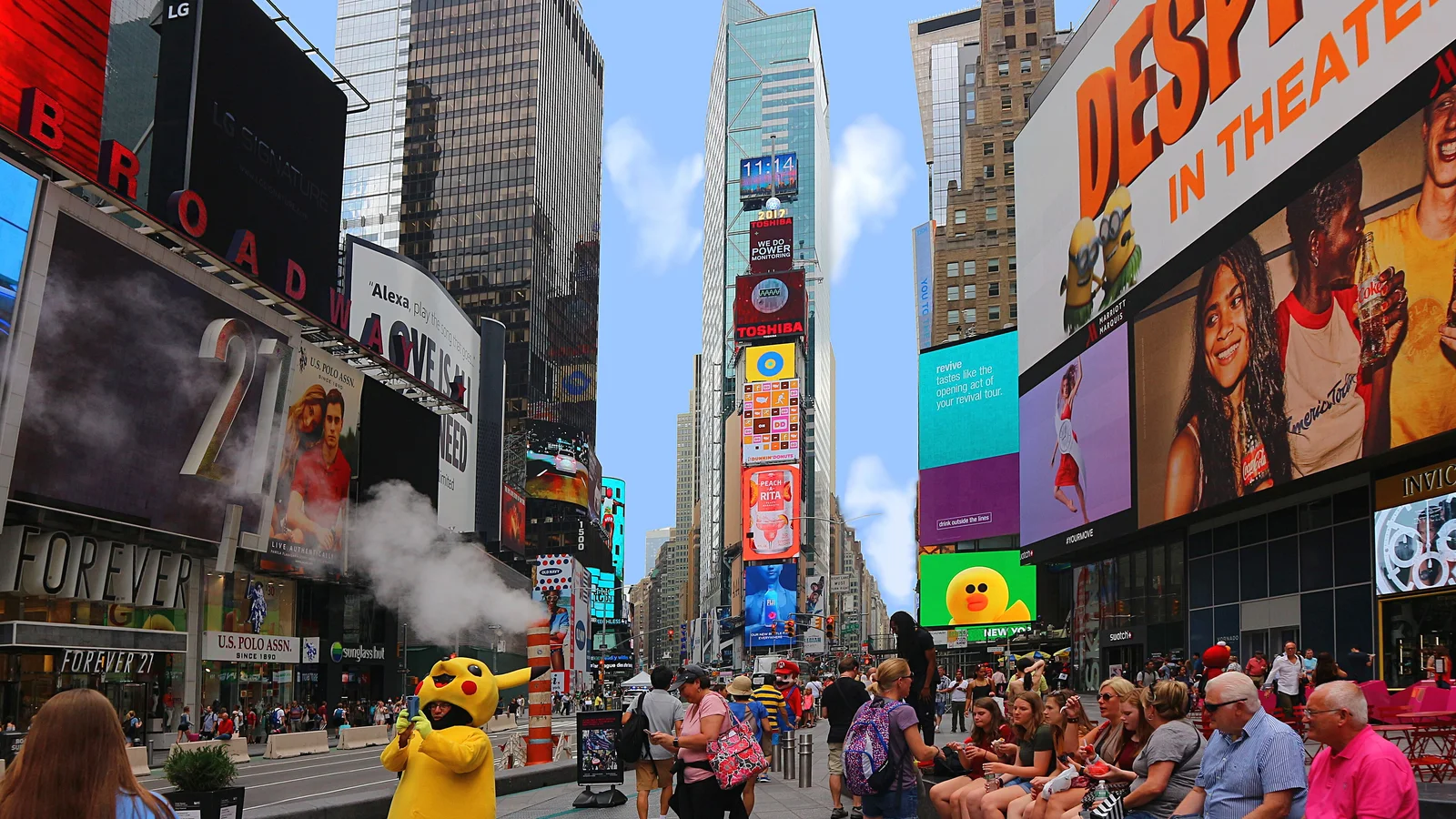 A dense crowd of pedestrians and tourists moving through Times Square in New York.