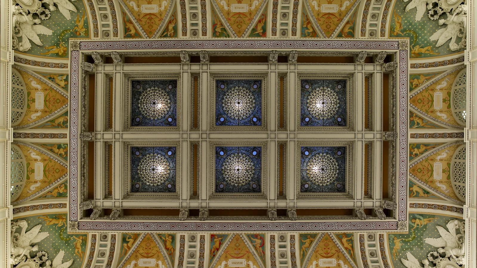 Ornate Great Hall interior at the Library of Congress with arches, stained glass and murals.
