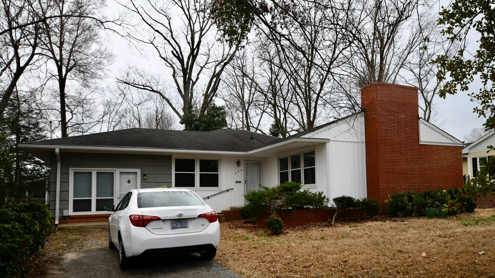 Detached houses line a leafy residential street in Raleigh, North Carolina.