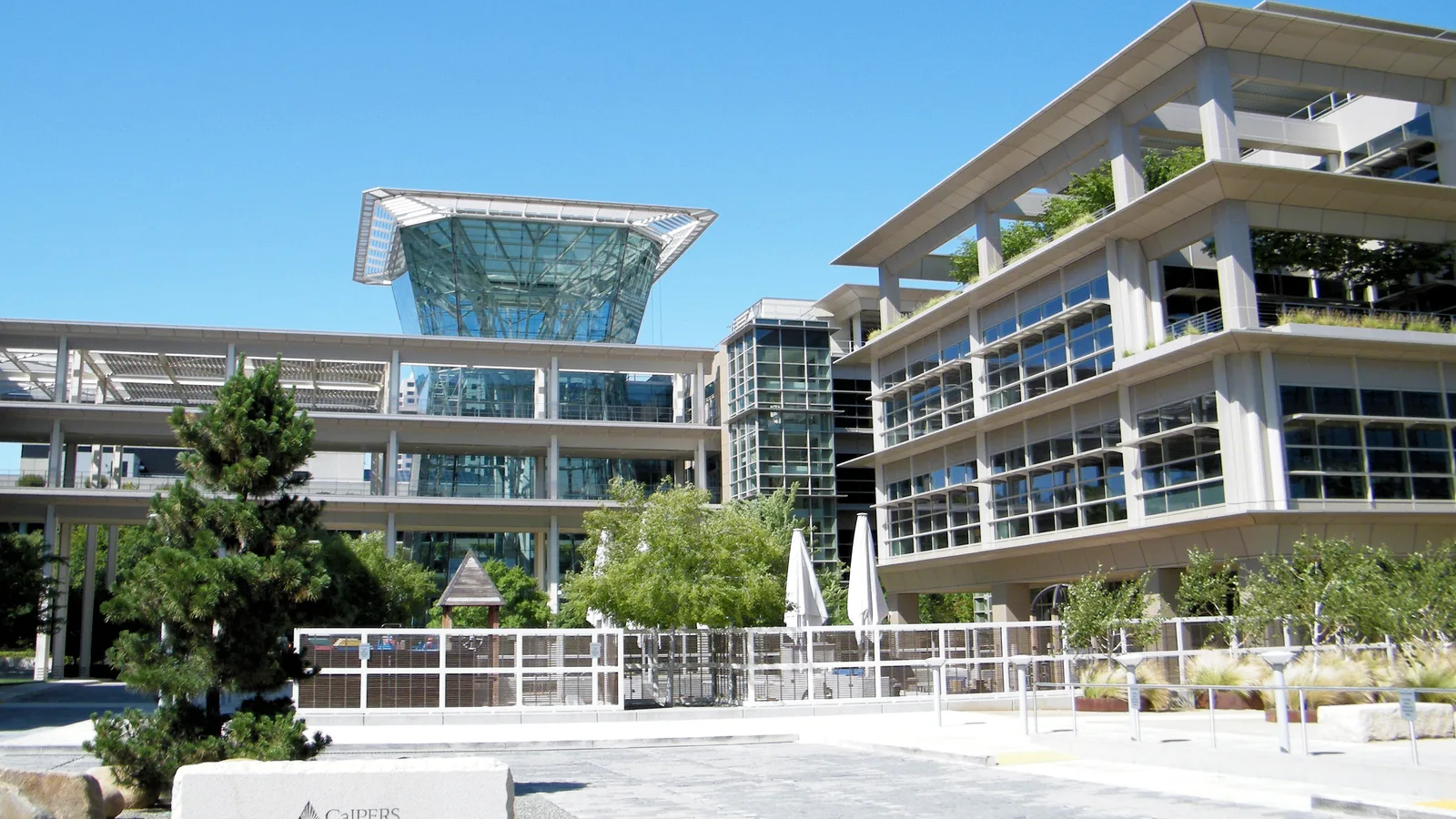 Modern glass-and-stone CalPERS headquarters building in Sacramento.