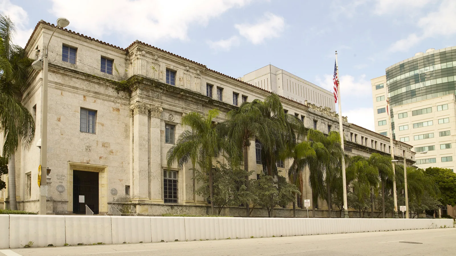 Historic federal courthouse with columns and palm trees in Miami.