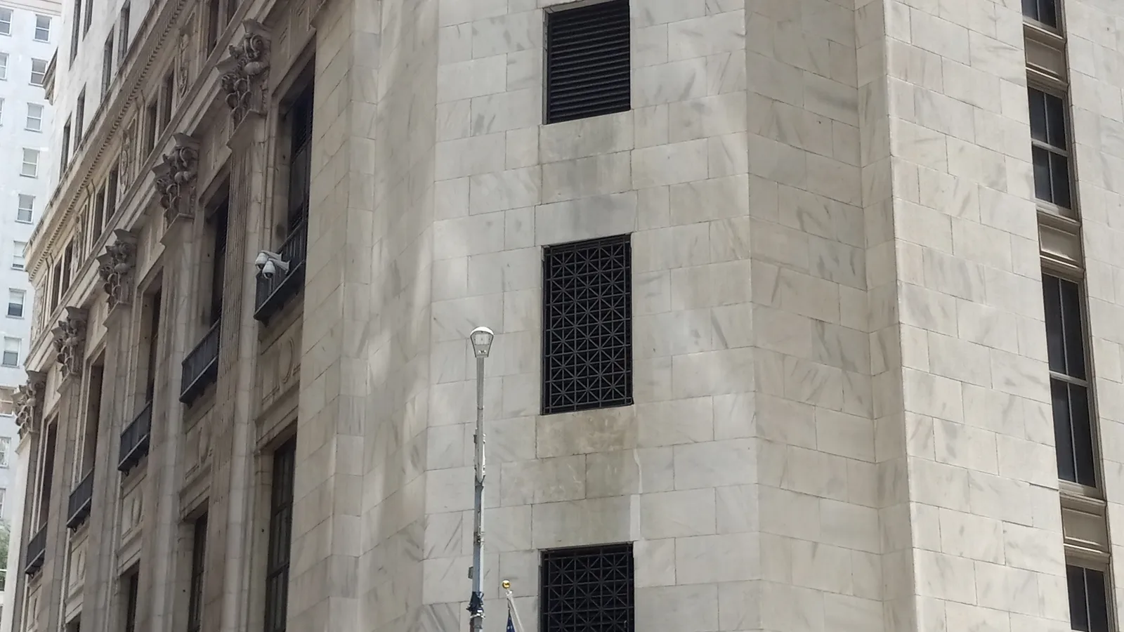 Stone facade and columns of the New York Stock Exchange on Wall Street.