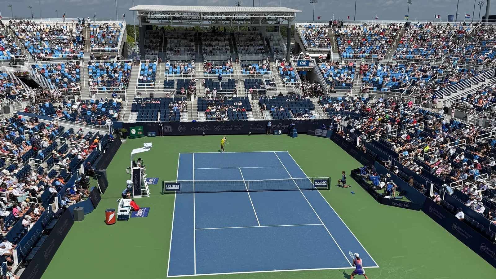 A tennis match in progress on Center Court at the Cincinnati Open with spectators in the stands.