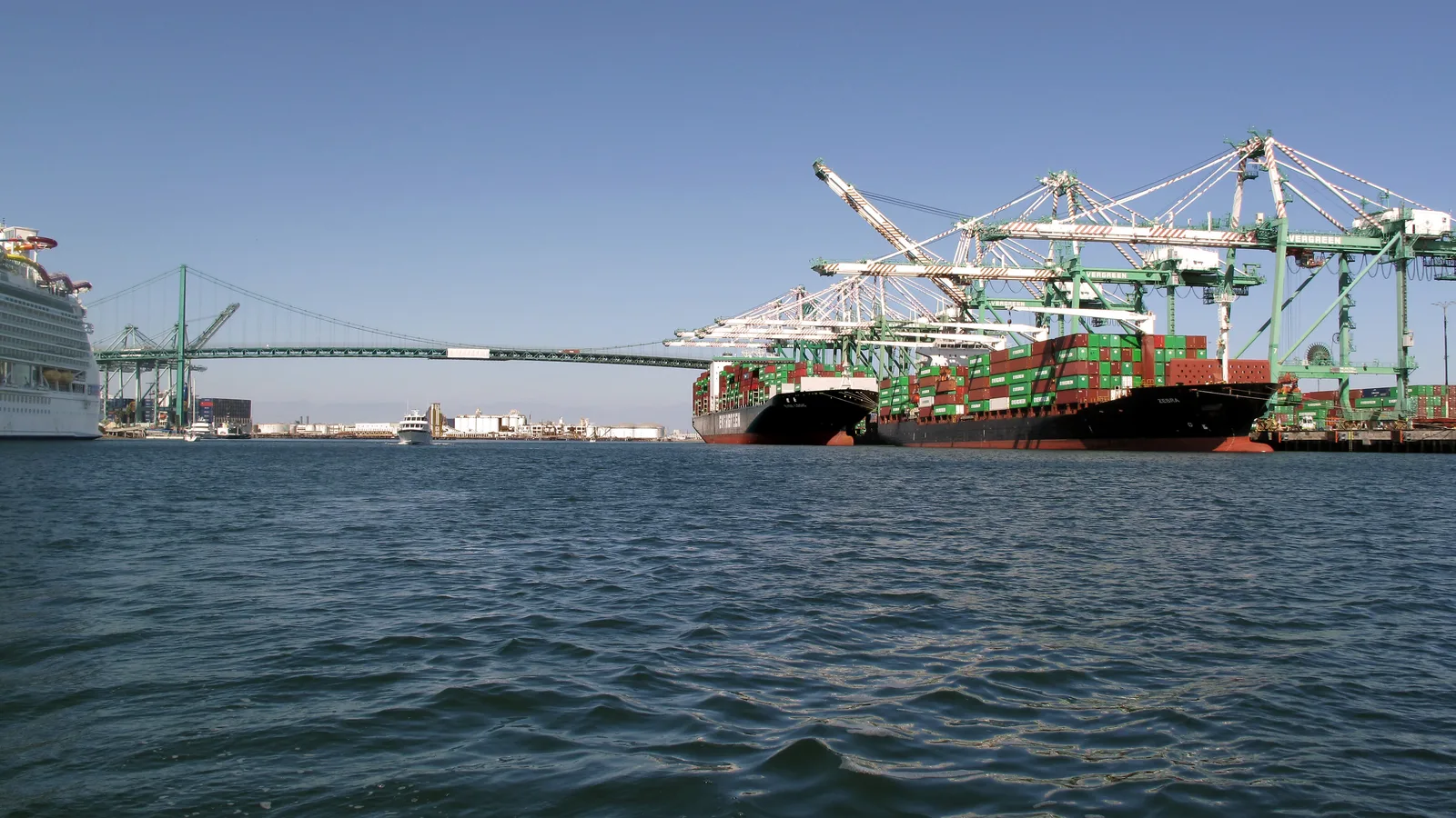 Container ships being loaded and unloaded by cranes at the Port of Los Angeles.