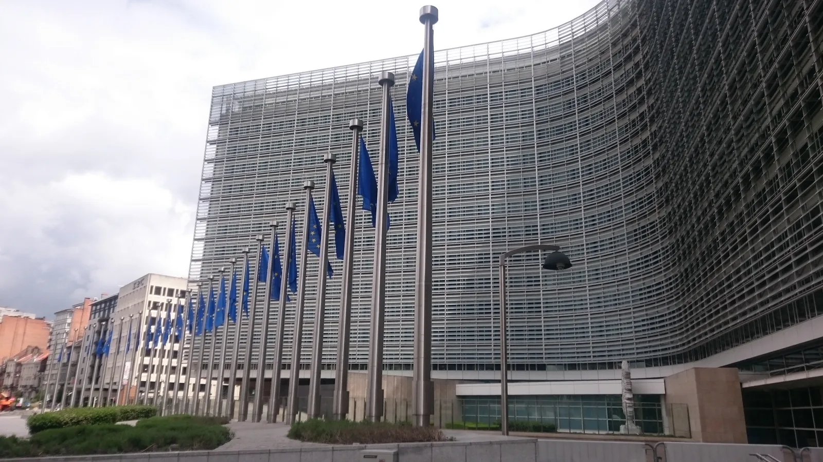 Curved glass and steel facade of the Berlaymont building in Brussels.
