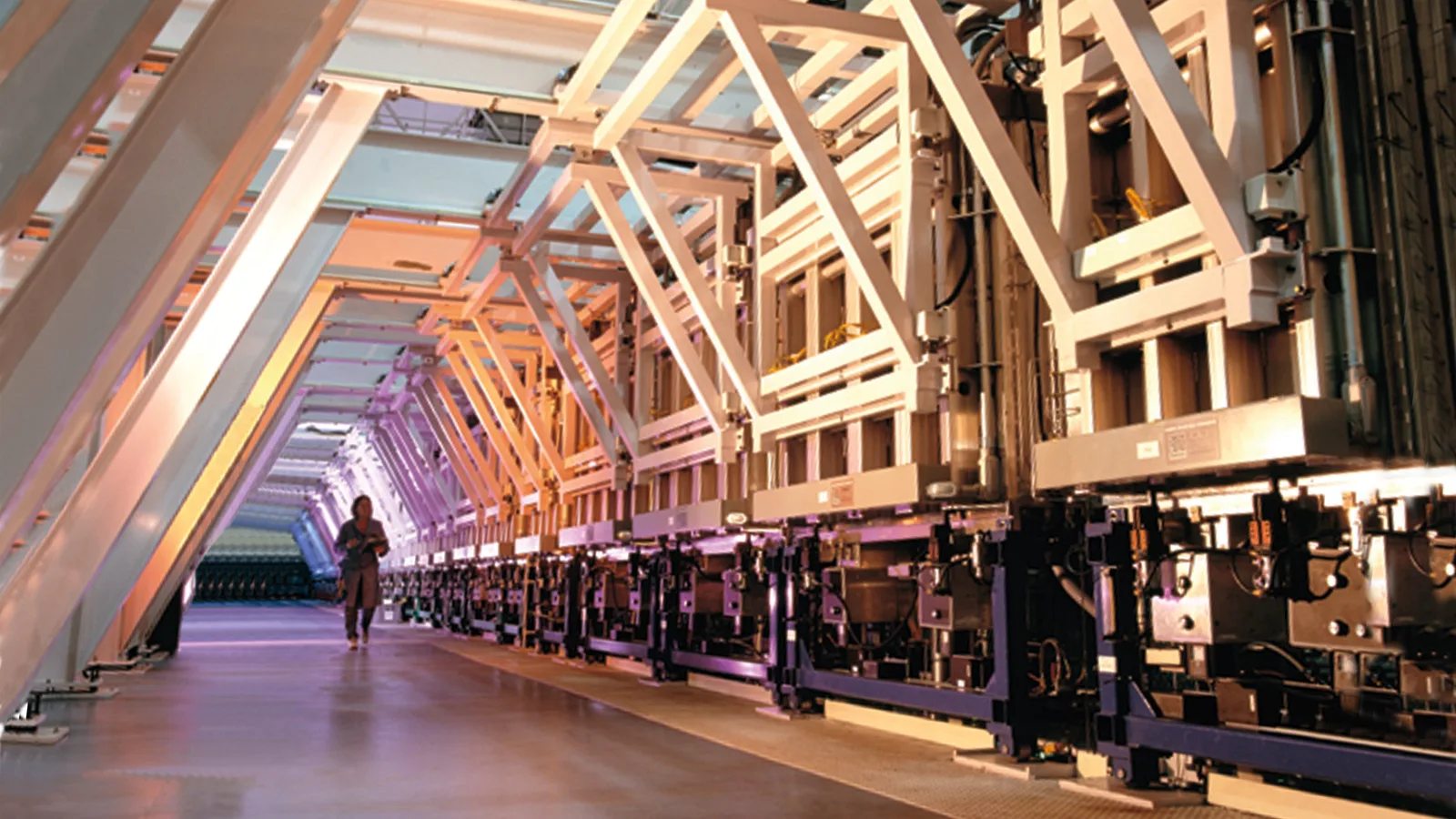 Workers and industrial equipment on a solar photovoltaic manufacturing line.