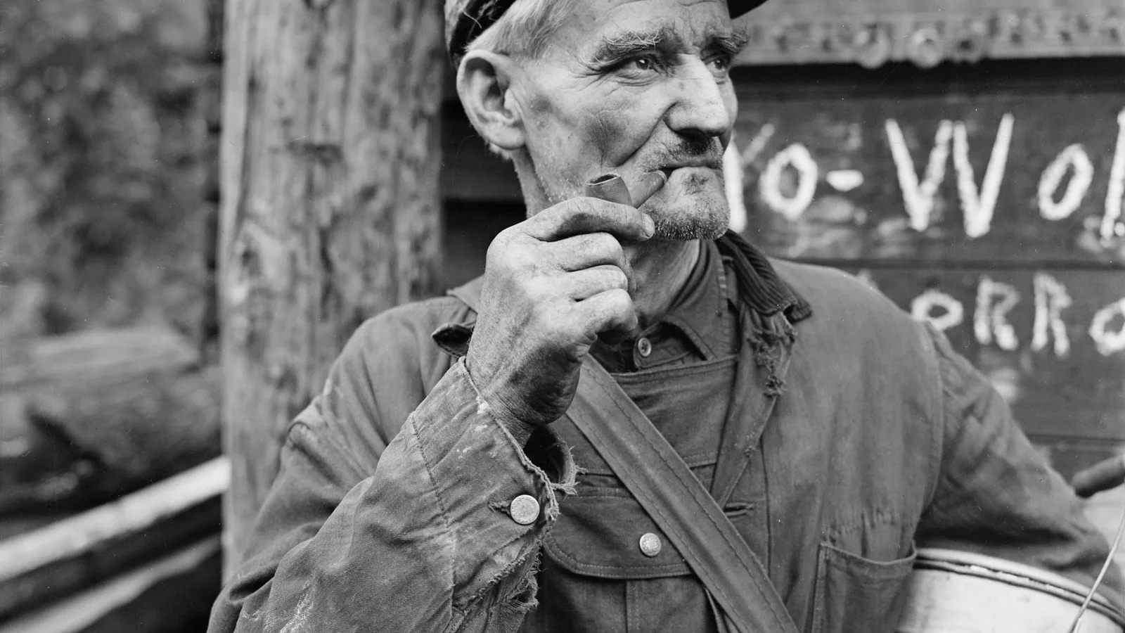 A coal miner wearing a helmet and work clothes stands underground in a Kentucky mine.