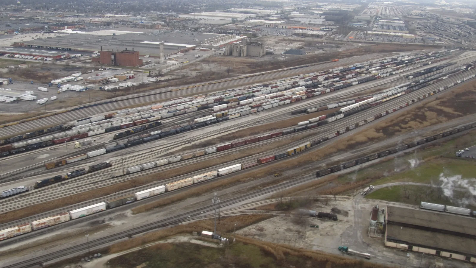 Multiple freight-train tracks and railcars spread across the Belt Railway clearing yard in Chicago.