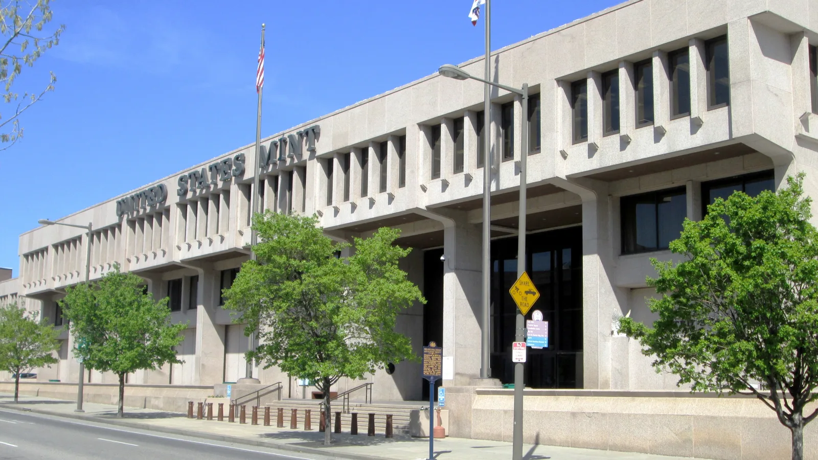 Modern United States Mint building in Philadelphia viewed from the street.