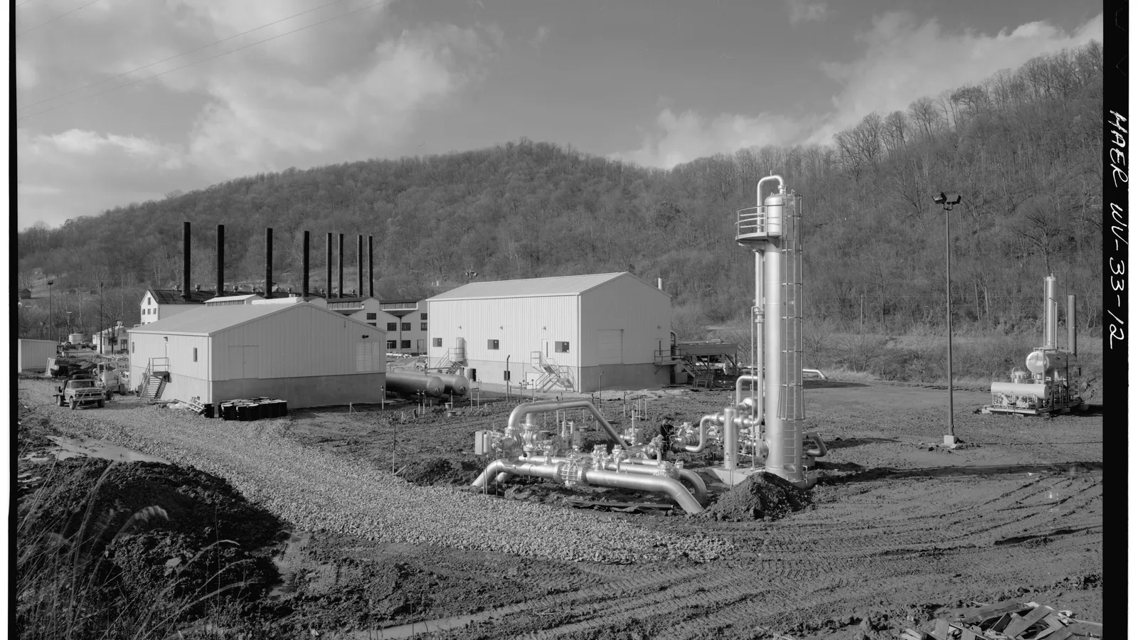 Industrial natural-gas pumping station buildings and equipment in a West Virginia landscape.