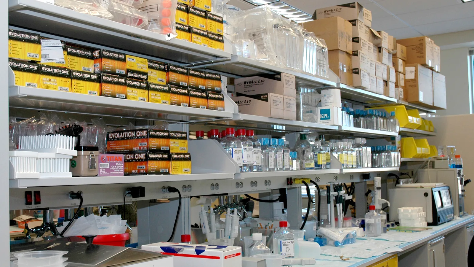 Researcher working at a laboratory bench with scientific equipment.
