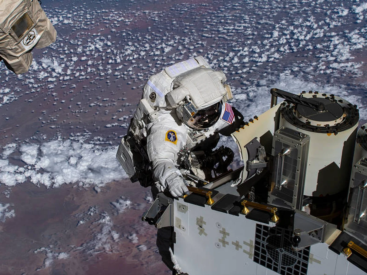 NASA astronaut Josh Cassada works outside the International Space Station above the Atlantic Ocean.