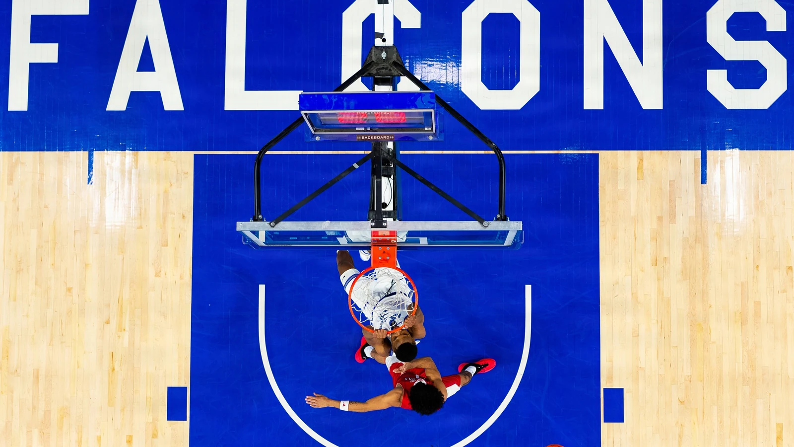 An Air Force basketball player rises for a dunk during a game at Clune Arena.