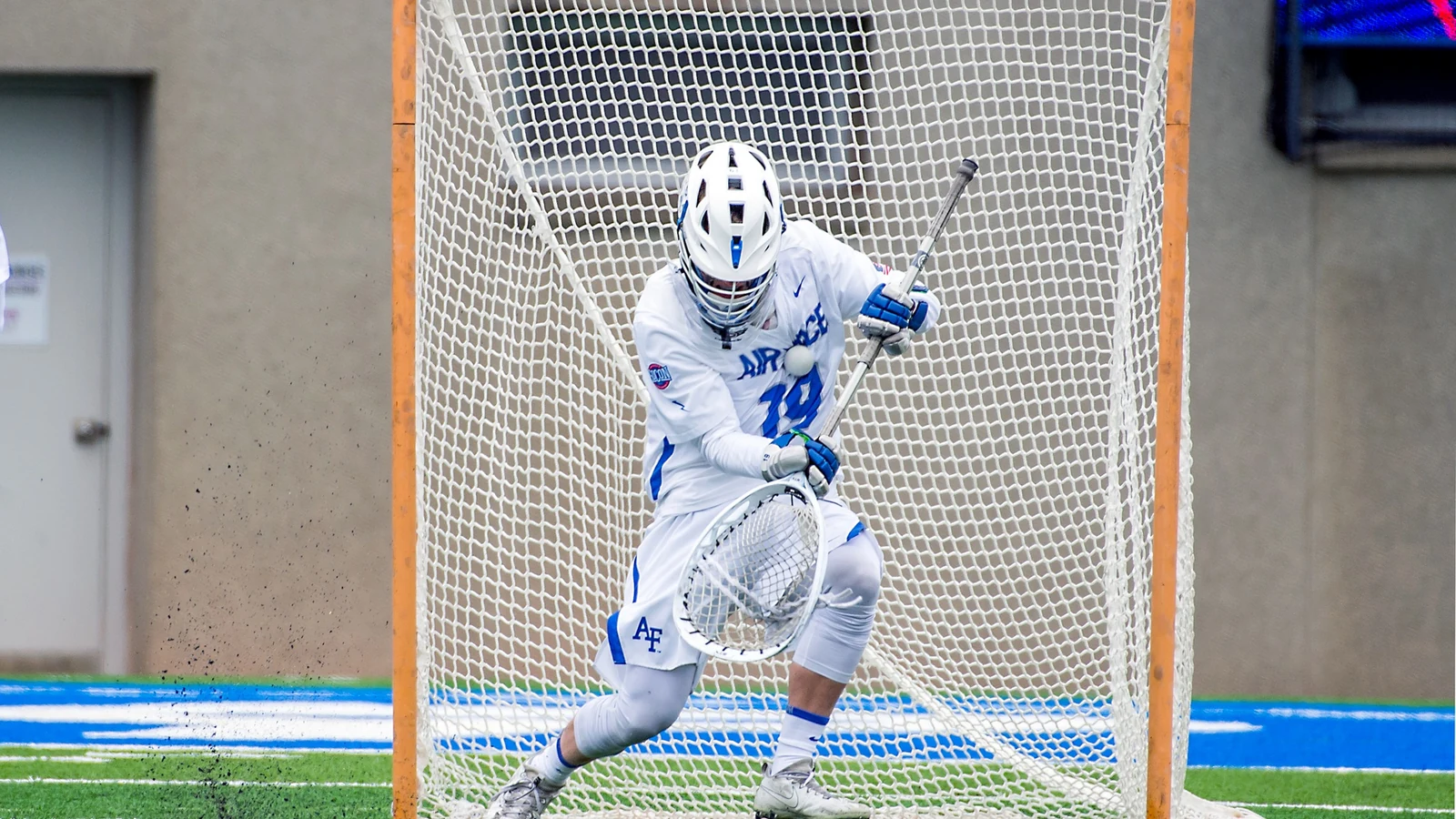 An Air Force lacrosse goalie blocks a close shot during a game at Falcon Stadium.