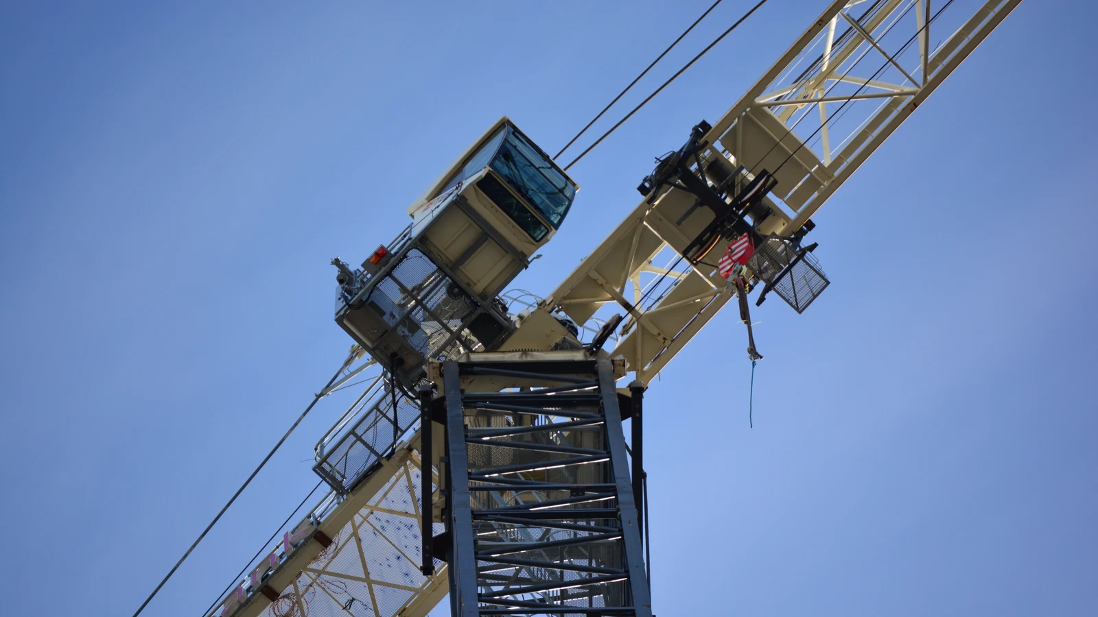 A tower crane rises above a multistory building under construction in Seattle.
