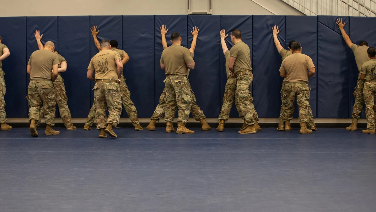 A line of National Guard members practices a wall-search position during corrections training in Albany, New York.